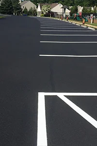 Image of a repaired asphalt parking lot in a residential area