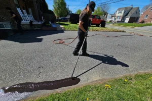 A residential driveway in the process of sealcoating - Superior Sealcoating in Glenmoore, PA - Superior Sealcoating