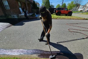 A residential driveway in the process of sealcoating - Superior Sealcoating in Limerick, PA - Superior Sealcoating