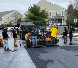 team members doing seal coating