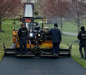 team members doing seal coating