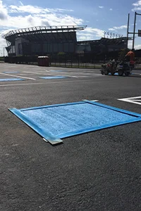 Image of the a stadium with a freshly sealcoated parking lot