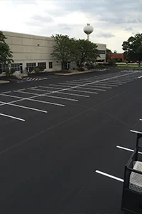 Image of a fresh sealcoating job in the parking lot of a business
