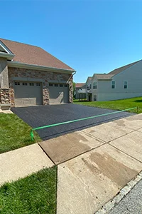 Image of a freshly sealcoated residential driveway