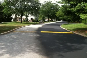 Image of a residential road that needs sealcoating