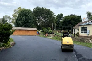 Image of a residential driveway in the process of sealcoating
