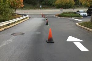 Image of a parking lot before and after sealcoating