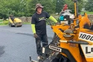 A Superior Sealcoating employee operating a paving machine - Paving in Downingtown, PA - Superior Sealcoating