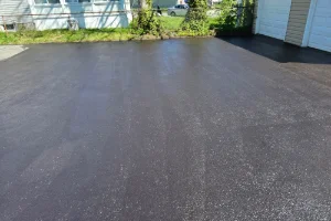 Image of a freshly sealcoated residential driveway