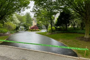 Image of a freshly sealcoated residential driveway