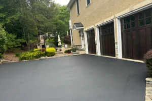 Image of a residential driveway in the process of sealcoating